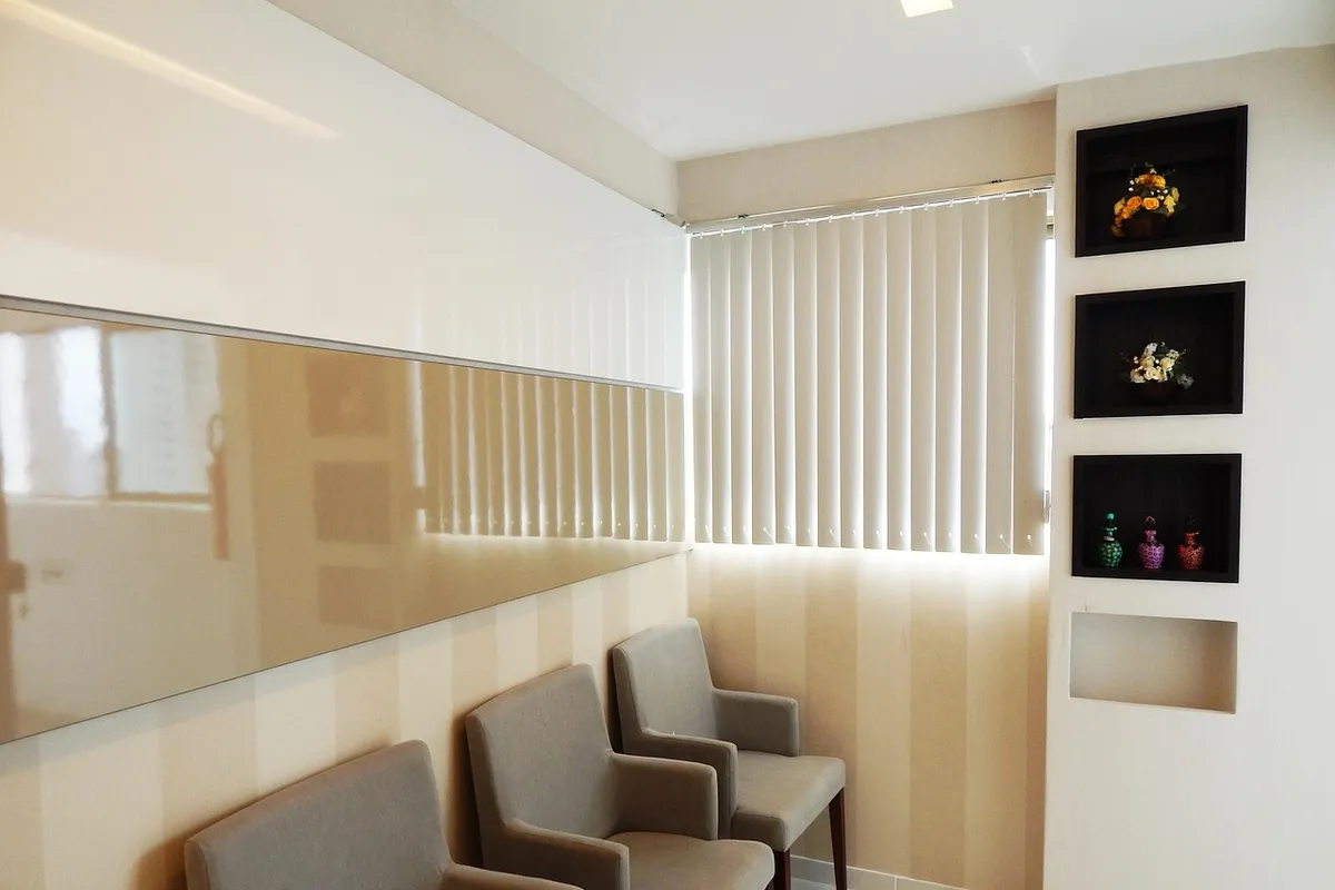 A clinic waiting room with plants and warm lighting