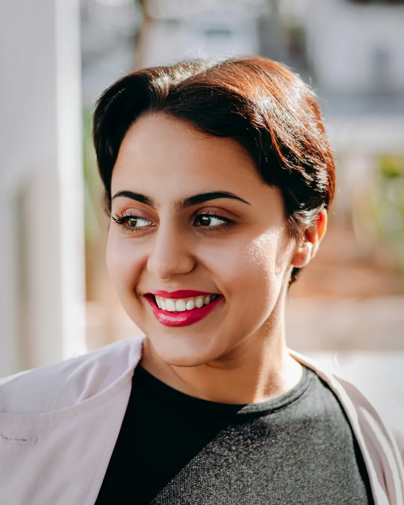 Portrait of Dr. Meghana Rao, a woman scientist in a lab coat
